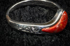 Red teardrop ring detail photograph