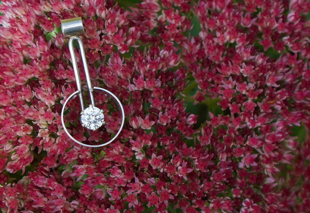 Drop encircled CZ pendant editorial photograph