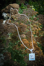 Large square CZ pendant editorial photograph