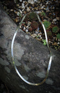 Thick strand herringbone necklace editorial photograph